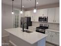 Modern kitchen featuring white cabinets and stainless steel appliances at 17868 W Blue Sky Dr, Surprise, AZ 85387