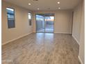 Spacious living room with tile flooring and access to the backyard at 17868 W Blue Sky Dr, Surprise, AZ 85387