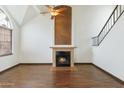 Bright living room features a fireplace, hardwood floors, and a ceiling fan at 18608 N 4Th Ave, Phoenix, AZ 85027