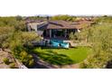 Home with pool and expansive lawn, mountain backdrop at 19198 N 95Th Pl, Scottsdale, AZ 85255