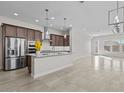 Modern kitchen with stainless steel appliances, dark wood cabinets, and an island at 19341 W San Juan Ave, Litchfield Park, AZ 85340