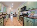 Updated kitchen with stylish mint green cabinets and granite countertops at 2021 W Osborn Rd, Phoenix, AZ 85015