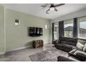 Bright living room with gray sofa and large TV at 22811 E Stacey Rd, Queen Creek, AZ 85142