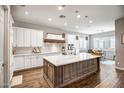 Modern kitchen featuring white cabinets, a large island, and stainless steel appliances at 2749 E Pearl St, Mesa, AZ 85213