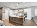 Spacious kitchen with white cabinets, an island, and hardwood floors at 2749 E Pearl St, Mesa, AZ 85213