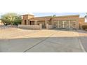 Home's exterior with a driveway and a view of the two-car garage with barn doors at 7341 E Sutton Dr, Scottsdale, AZ 85260