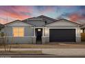 Charming single-story home with a well-manicured lawn, gray paint, and an attached two-car garage at 17703 W Southgate Ave, Goodyear, AZ 85338