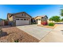Beautiful single-story home featuring a well-maintained lawn, desert landscaping, and a two-car garage at 20856 E Arroyo Verde Dr, Queen Creek, AZ 85142