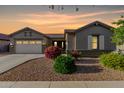 Charming single-story home with desert landscaping, two-car garage, and beautiful twilight sky at 20856 E Arroyo Verde Dr, Queen Creek, AZ 85142