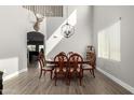 Bright dining room boasts high ceilings, stylish chandelier, and wood-look flooring at 28677 N Roselite Ln, San Tan Valley, AZ 85143