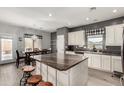 Open kitchen featuring an island with stool seating, granite countertops, and stainless appliances at 28677 N Roselite Ln, San Tan Valley, AZ 85143