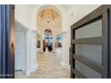 Grand entryway with arched doorways, tile floors, and views into the living area at 13503 E Charter Oak Dr, Scottsdale, AZ 85259