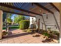 Landscaped backyard patio with wood beam pergola and decorative water feature at 15233 N 5Th Ave, Phoenix, AZ 85023