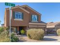 Two-story house with a tan exterior, two-car garage, and landscaping at 306 N 21St Cir, Coolidge, AZ 85128