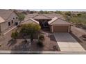 Beautiful aerial view of single story house with desert landscaping and concrete driveway, showcasing the neighborhood at 5217 S Crested Saguaro Ln, Gold Canyon, AZ 85118