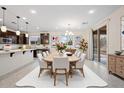 Open-concept dining area with modern chandelier, and sliding glass doors for indoor-outdoor living at 5531 W Gwen St, Laveen, AZ 85339