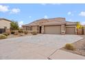 Two-story house with a three-car garage and well-manicured lawn at 5531 W Gwen St, Laveen, AZ 85339