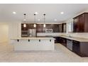 A spacious kitchen features granite countertops, stainless steel appliances, and a large island at 5531 W Gwen St, Laveen, AZ 85339