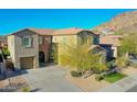 Two-story house with attached garage and mountain views at 27486 N 89Th Dr, Peoria, AZ 85383