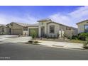 Attractive single-story home featuring desert landscaping, a two-car garage, and a cozy front entrance at 40015 W Crane Dr, Maricopa, AZ 85138
