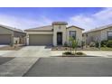 Inviting single-story home with desert landscaping, a two-car garage, and a covered front entry at 40015 W Crane Dr, Maricopa, AZ 85138
