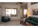 Bright living room with comfortable seating, neutral carpet, and an open view to the outdoor patio at 8598 E Saguaro Blossom Rd, Gold Canyon, AZ 85118