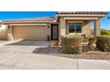 House exterior featuring a two-car garage and well-manicured landscaping at 1744 E 16Th Ave, Apache Junction, AZ 85119