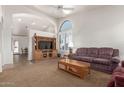 Living room with vaulted ceiling, a built-in entertainment center, and comfortable seating at 20020 N 21St St, Phoenix, AZ 85024