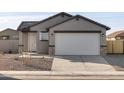 Newly built home with gray exterior, two-car garage, and small front yard at 2665 E Santa Ynez Dr, Casa Grande, AZ 85194