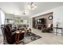 Spacious living room with leather recliners and a fireplace at 31627 N Poncho Ln, San Tan Valley, AZ 85143