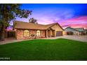 Charming brick home with a spacious lawn and gated entry at 4343 E Downing St, Mesa, AZ 85205