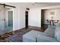 Bright living room featuring hardwood floors, a comfortable sofa, and a dining area at 837 E Echo Ln, Phoenix, AZ 85020