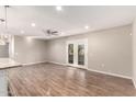 Spacious living room, featuring wood-look floors and french doors at 18609 N Kiva Dr, Sun City, AZ 85373