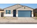 Charming single-story home showcasing a well-maintained front yard and a blue two-car garage at 37028 W Prado St, Maricopa, AZ 85138