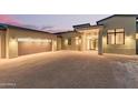 Modern home exterior with glass entry doors and lighting at 40564 N 50Th St, Cave Creek, AZ 85331