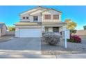 Two-story house with a white exterior, landscaping, and a two-car garage at 10350 W Alvarado Rd, Avondale, AZ 85392