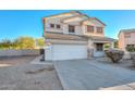 Two-story house with a white exterior, landscaping, and a two-car garage at 10350 W Alvarado Rd, Avondale, AZ 85392