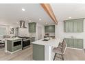 Open concept kitchen featuring stainless steel appliances and a large island at 1829 E Amelia Ave, Phoenix, AZ 85016