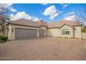 Two-car garage with a brick facade and large driveway at 2090 E Coconino Ct, Gilbert, AZ 85298