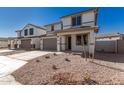 Two story house with gray garage doors and desert landscaping at 31730 N Waddle Ln, San Tan Valley, AZ 85143