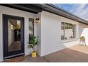 Modern entryway with a sleek black door and stylish planter at 6262 N 85Th St, Scottsdale, AZ 85250