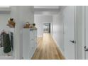 Bright hallway with light wood flooring and white storage cabinet at 1337 N Rosemont --, Mesa, AZ 85205