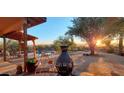 Sunset view over the backyard patio with a fire pit and pool at 30247 N 164Th St, Scottsdale, AZ 85262