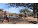 Round pool with a pergola, mountain views, and desert landscaping at 30247 N 164Th St, Scottsdale, AZ 85262