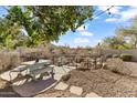 Relaxing backyard oasis with a stone water feature and patio seating at 20436 N 17Th Pl, Phoenix, AZ 85024