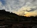 Sunset view from backyard, featuring a metal fence and desert landscape at 20436 N 17Th Pl, Phoenix, AZ 85024