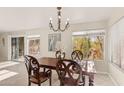 Bright dining room with a wooden table and chandelier at 20436 N 17Th Pl, Phoenix, AZ 85024