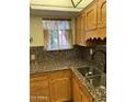 Kitchen with granite countertops and wood cabinets at 3325 W Belmont Ave, Phoenix, AZ 85051