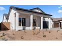 Attractive house featuring a covered porch with robust support columns and easy-care desert landscaping at 42140 N Golden Trl, San Tan Valley, AZ 85140