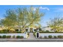 White two-story home with manicured landscaping and a gated entryway at 6229 E Gold Dust Ave, Paradise Valley, AZ 85253